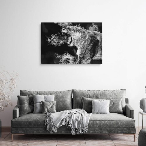 Black and White Lioness - Canvas Wall Art. The monochromatic composition adds a timeless and dramatic quality to the scene, emphasizing the lioness's fierce expression and the intricate textures of her fur. The intensity of her roar resonates through the image, evoking a sense of awe and respect for the queen of the savannah.