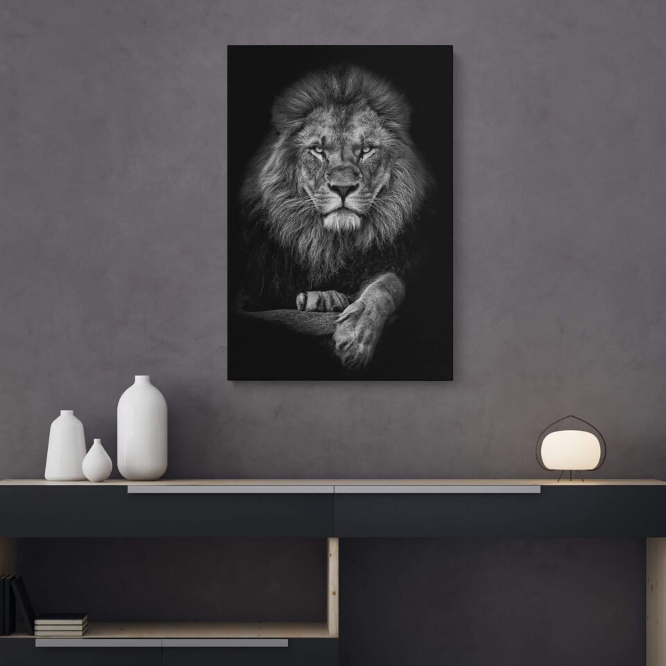 Majestic Monarch - Animal Prints - Black and White Portrait of the Lion on Canvas Art Prints. The monochrome composition adds a timeless and dramatic quality to the image, accentuating the lion's fierce expression, intricate mane, and the depth of its penetrating gaze. The contrasting tones create a striking visual impact, evoking a sense of reverence for the ruler of the animal kingdom.